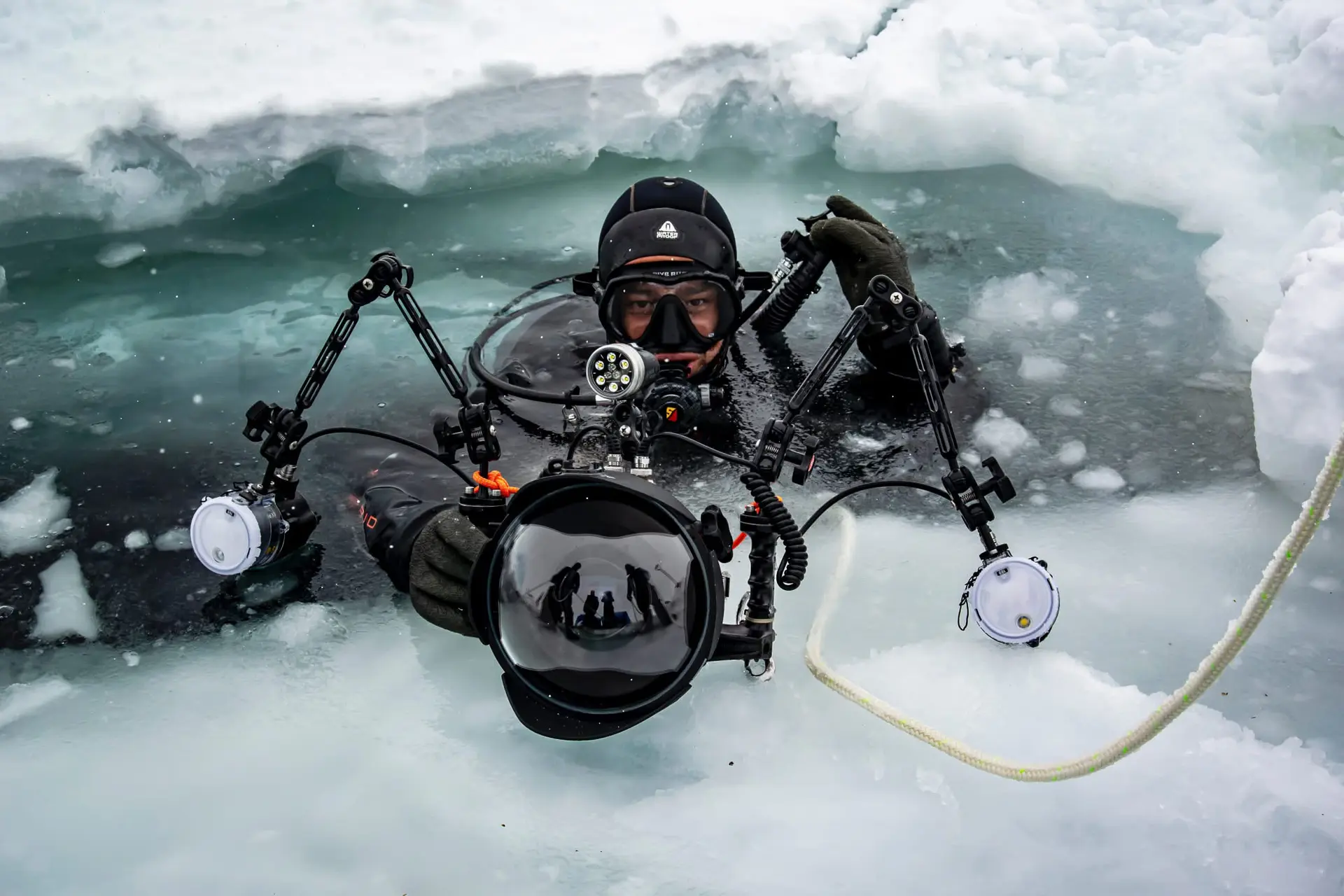 ZOTZ underwater photographer emerging through polar ice